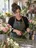 A flower shop owner at her work table.