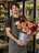 A young florist with a bucket of dahlias