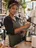 A café owner behind her espresso machine.