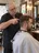 A barber at his chair.