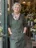 A florist in her shop doorway